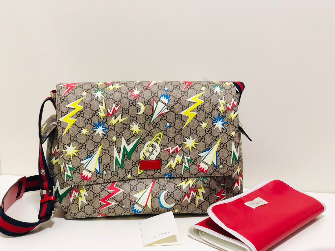 GUCCI GG Supreme Baby Changing Bag. Original Quality Bag including gift box, care book, dust bag, authenticity card. A baby changing bag crafted from Supreme canvas is animated by a print that recalls outer space–a theme used throughout Gucci's collections. Set against the House's emblematic monogram motif, the baby changing diaper bag is defined by spaceships, stars, and images from the galaxy. Also, outer space continues to influence Gucci's latest collections in new, whimsical ways.