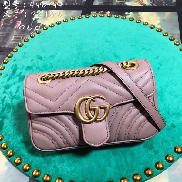 GUCCI GG Marmont Matelassé Mini Bag. High-end quality bag including gift box, literature, dust bag, authenticity card. The small GG Marmont chain shoulder bag has a softly structured shape and an oversized flap closure with Double G hardware. The sliding chain strap can be worn in multiple ways, changing between a shoulder and a top handle bag. Made in matelassé chevron leather with a heart on the back.