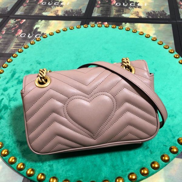 GUCCI GG Marmont Matelassé Mini Bag. High-end quality bag including gift box, literature, dust bag, authenticity card. The small GG Marmont chain shoulder bag has a softly structured shape and an oversized flap closure with Double G hardware. The sliding chain strap can be worn in multiple ways, changing between a shoulder and a top handle bag. Made in matelassé chevron leather with a heart on the back.