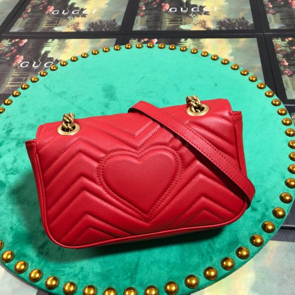 GUCCI GG Marmont Matelassé Mini Bag. High-end quality bag including gift box, literature, dust bag, authenticity card. The small GG Marmont chain shoulder bag has a softly structured shape and an oversized flap closure with Double G hardware. The sliding chain strap can be worn in multiple ways, changing between a shoulder and a top handle bag. Made in matelassé chevron leather with a heart on the back.