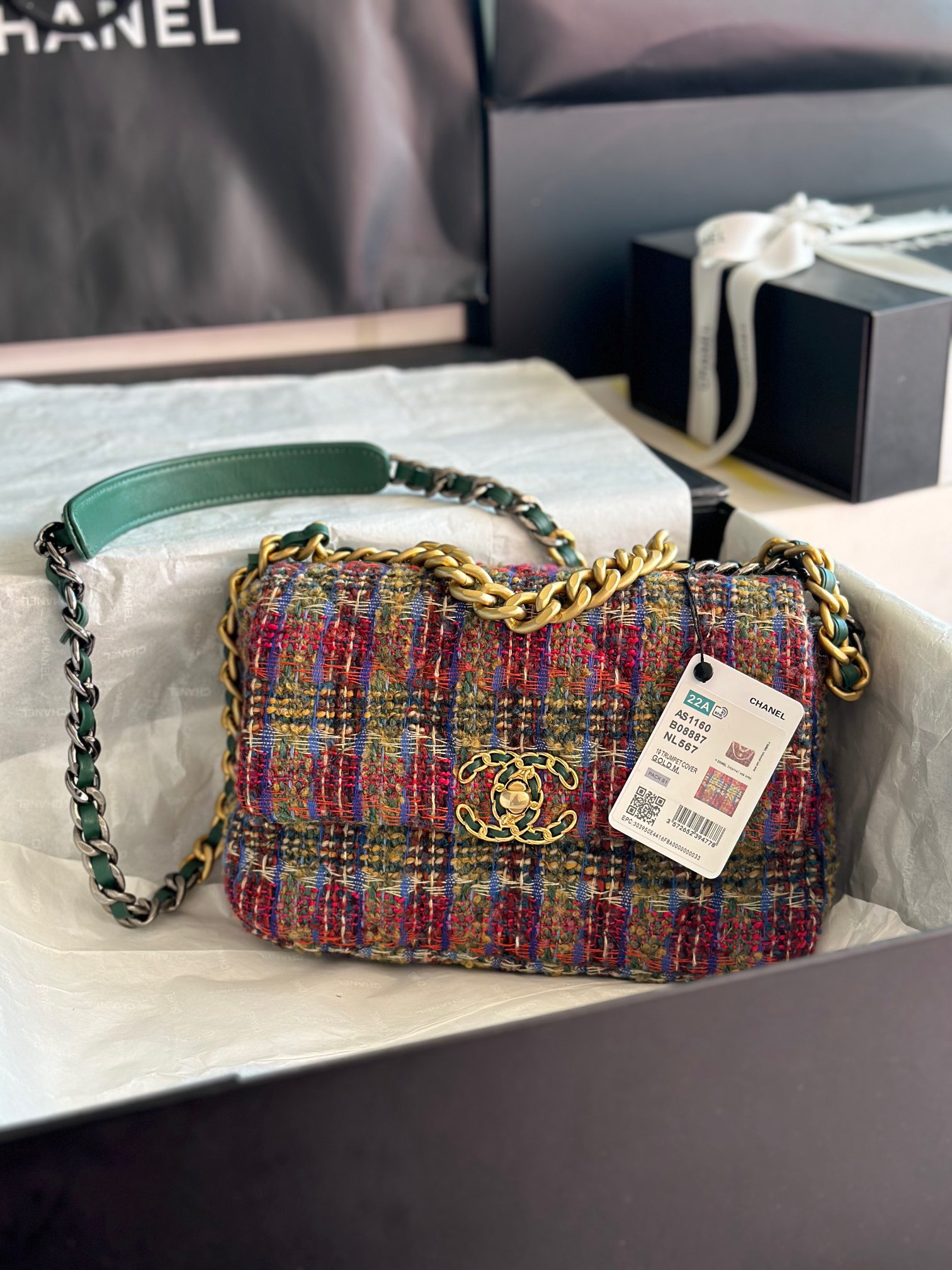 CHANEL 19 Tweed Flap Bag. Original Quality Bag including gift box, care book, dust bag, authenticity card. This Chanel 19 Flap Bag ticks all boxes and is quite possibly the most sought after bag in the world at this moment. Constructed from beautifully constructed Tweed Fibres and paired with the iconic Chanel 19 two-tone hardware, both Gold and Ruthenium. The refined bag features an aged gold chain detail CC turn-lock on the flap, a magnetic snap pocket at the rear and a leather threaded gradient gold to ruthenium chain-link strap with a leather shoulder pad. The front flap opens to a black fabric interior with a zipper pocket. This versatile bag with soft leather is an essential bag for any Chanel aficionado.