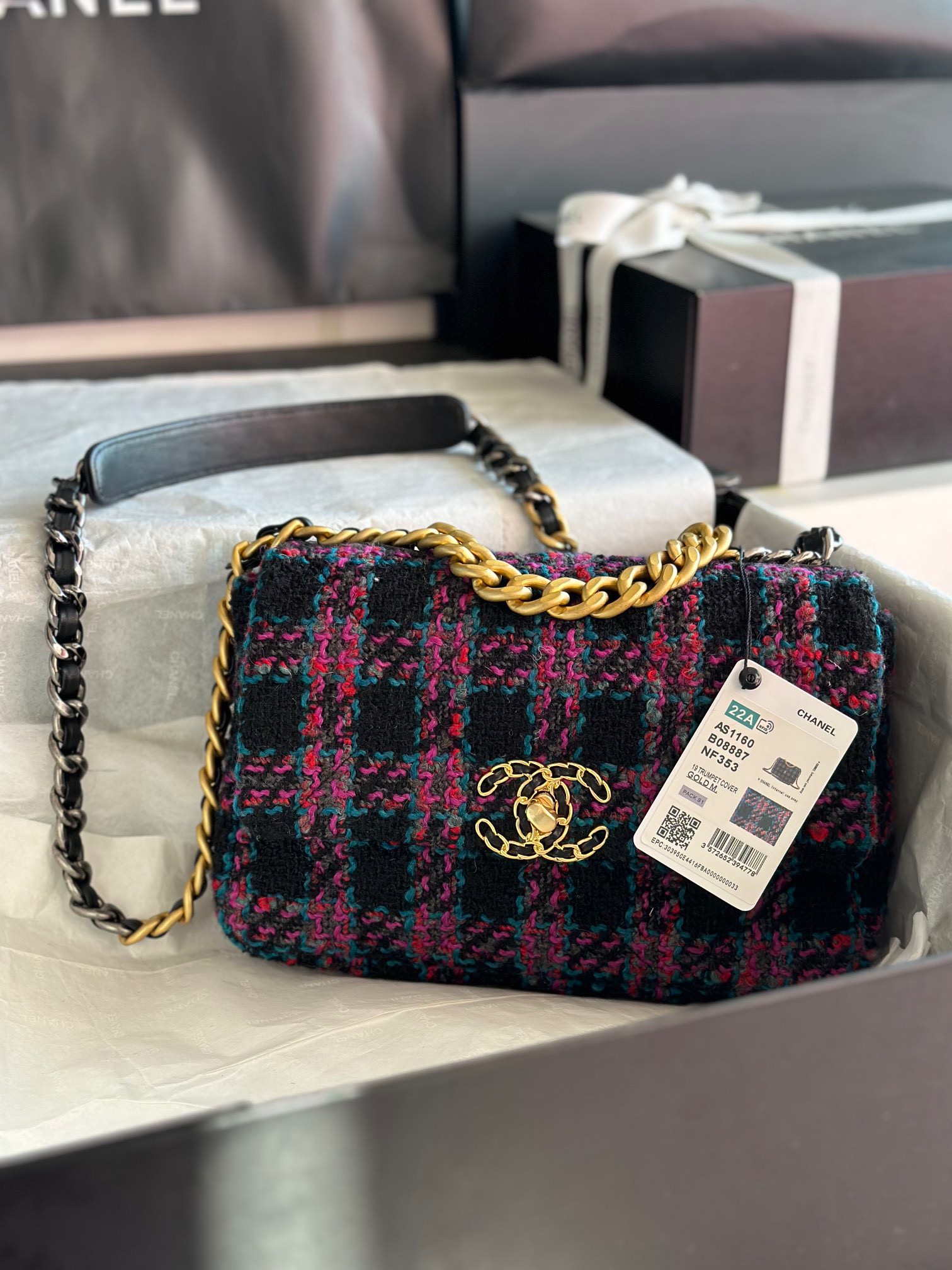 CHANEL 19 Tweed Flap Bag. Original Quality Bag including gift box, care book, dust bag, authenticity card. This Chanel 19 Flap Bag ticks all boxes and is quite possibly the most sought after bag in the world at this moment. Constructed from beautifully constructed Tweed Fibres and paired with the iconic Chanel 19 two-tone hardware, both Gold and Ruthenium. The refined bag features an aged gold chain detail CC turn-lock on the flap, a magnetic snap pocket at the rear and a leather threaded gradient gold to ruthenium chain-link strap with a leather shoulder pad. The front flap opens to a black fabric interior with a zipper pocket. This versatile bag with soft leather is an essential bag for any Chanel aficionado.