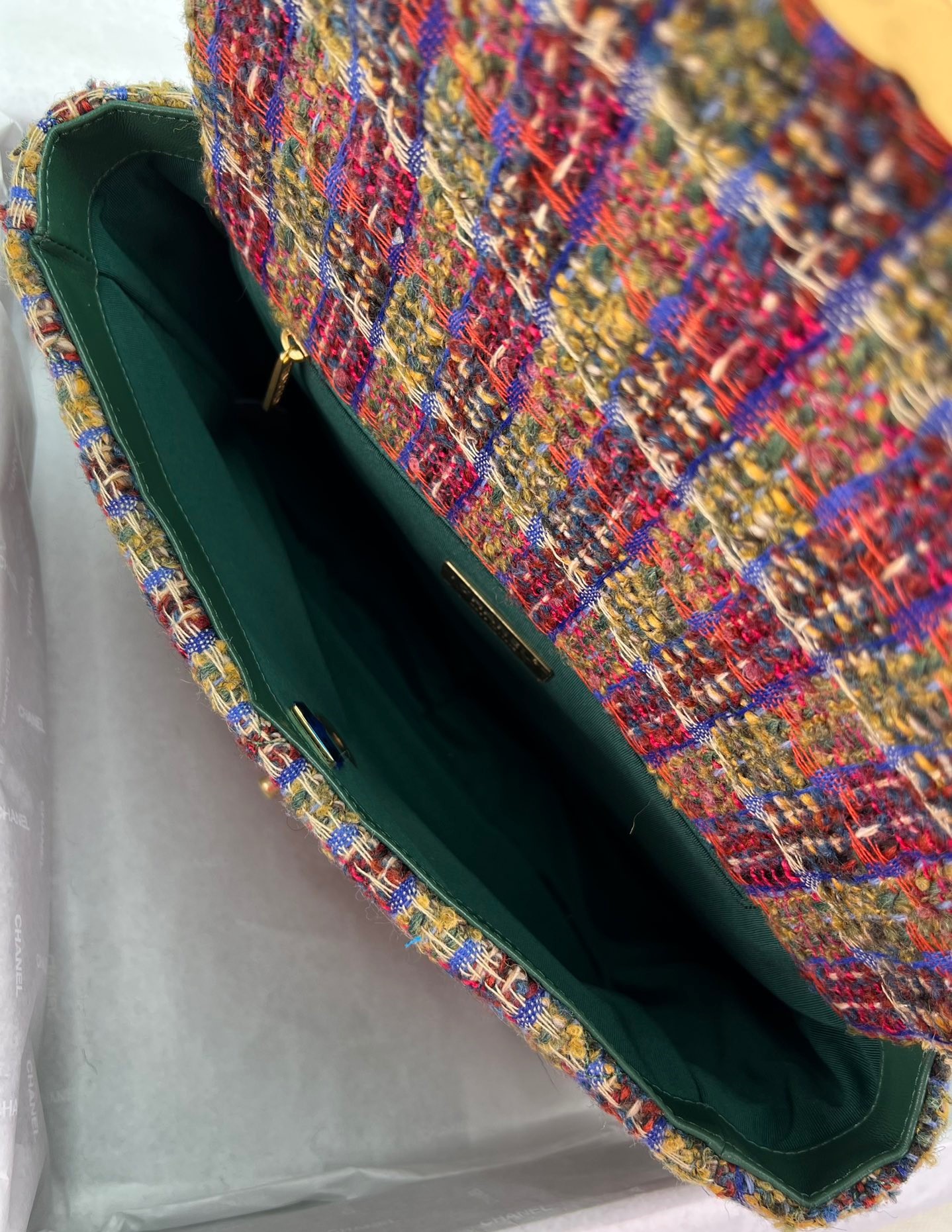 CHANEL 19 Tweed Flap Bag. Original Quality Bag including gift box, care book, dust bag, authenticity card. This Chanel 19 Flap Bag ticks all boxes and is quite possibly the most sought after bag in the world at this moment. Constructed from beautifully constructed Tweed Fibres and paired with the iconic Chanel 19 two-tone hardware, both Gold and Ruthenium. The refined bag features an aged gold chain detail CC turn-lock on the flap, a magnetic snap pocket at the rear and a leather threaded gradient gold to ruthenium chain-link strap with a leather shoulder pad. The front flap opens to a black fabric interior with a zipper pocket. This versatile bag with soft leather is an essential bag for any Chanel aficionado.