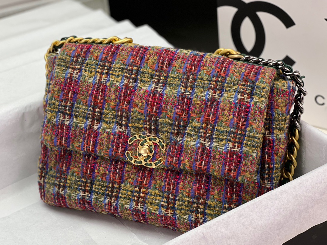 CHANEL 19 Tweed Flap Bag. Original Quality Bag including gift box, care book, dust bag, authenticity card. This Chanel 19 Flap Bag ticks all boxes and is quite possibly the most sought after bag in the world at this moment. Constructed from beautifully constructed Tweed Fibres and paired with the iconic Chanel 19 two-tone hardware, both Gold and Ruthenium. The refined bag features an aged gold chain detail CC turn-lock on the flap, a magnetic snap pocket at the rear and a leather threaded gradient gold to ruthenium chain-link strap with a leather shoulder pad. The front flap opens to a black fabric interior with a zipper pocket. This versatile bag with soft leather is an essential bag for any Chanel aficionado.