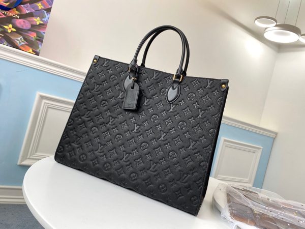 LOUIS VUITTON Onthego GM Monogram Empreinte Leather Tote. High-end quality bag including gift box, literature, dust bag, authenticity card. The stylishly oversized LV Onthego GM tote goes from workday to weekend without missing a beat. The bag’s square shape affords plenty of room for storing office files and a laptop. For the first time, this model is offered in Monogram Empreinte Giant, a supple embossed leather. Versatile, it can be carried by hand or worn over the shoulder on its two long straps.