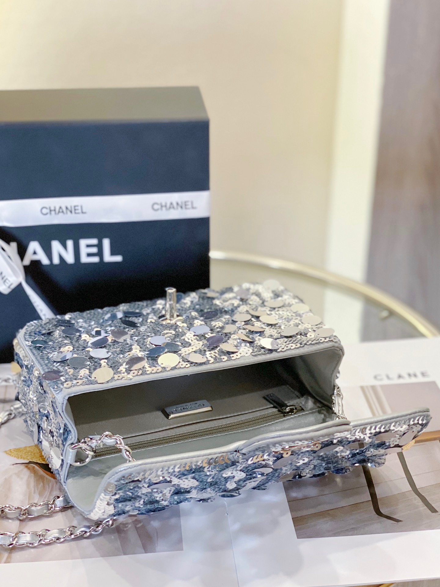 CHANEL Mini Flap Bag In Sequins. Original Quality Bag including gift box, care book, dust bag, authenticity card. This small sleek flap bag is beautifully crafted of the layering of small and large sequins that create the entire surface of the bag. The elegant handbag features polished chain link leather threaded shoulder straps and a Chanel CC turn lock. This opens to a leather interior with room for your necessities for day or evening with the timeless style.