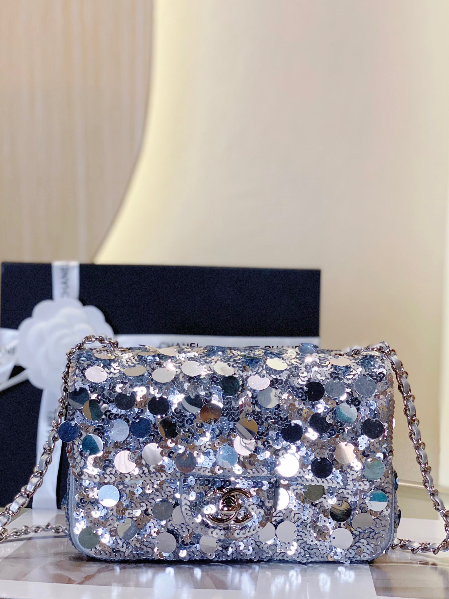 CHANEL Mini Flap Bag In Sequins. Original Quality Bag including gift box, care book, dust bag, authenticity card. This small sleek flap bag is beautifully crafted of the layering of small and large sequins that create the entire surface of the bag. The elegant handbag features polished chain link leather threaded shoulder straps and a Chanel CC turn lock. This opens to a leather interior with room for your necessities for day or evening with the timeless style.