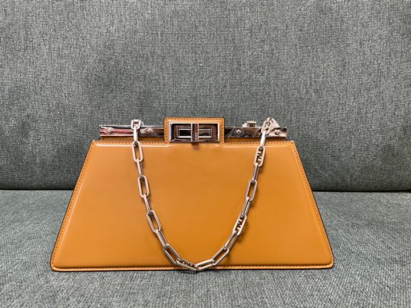 FENDI Peekaboo Cut. Original Quality Bag including gift box, care book, dust bag, authenticity card. Peekaboo Cut bag made of glossy leather. A new evolution of the iconic Peekaboo ISeeU, it has a striking horizontal cut that accentuates its classic features and reveals the metal bar and the iconic twist lock on both sides. It can be carried by hand or on the shoulder thanks to the chain embellished with O’Lock details.