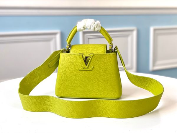 LOUIS VUITTON Capucines Mini. Original Quality Bag including gift box, literature, dust bag, authenticity card. Fashioned from vibrantly colored Taurillon leather, the Capucines Mini handbag pops. The fresh new colorway is perfectly complemented by the discreet metal handle rings. Like all Capucines, the Mini can be carried with the flap out for simple sophistication or tucked inside to feature the LV Initials.