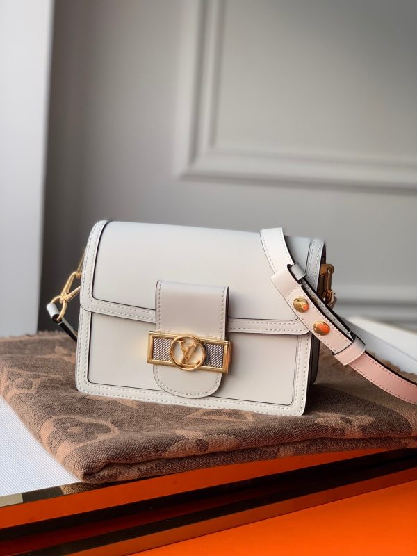 LOUIS VUITTON Mini Dauphine Crossbody and Shoulder Bag. Original Quality Bag including gift box, literature, dust bag, authenticity card. LOUIS VUITTON is expanding its Dauphine family with the Lugano Mini. In smooth calfskin leather, it features striking new signature touches like a gold LV circle lock trimmed with silver guilloche. Refined, elegant styling and convenient carry options make this bag a must-have for Dauphine lovers.