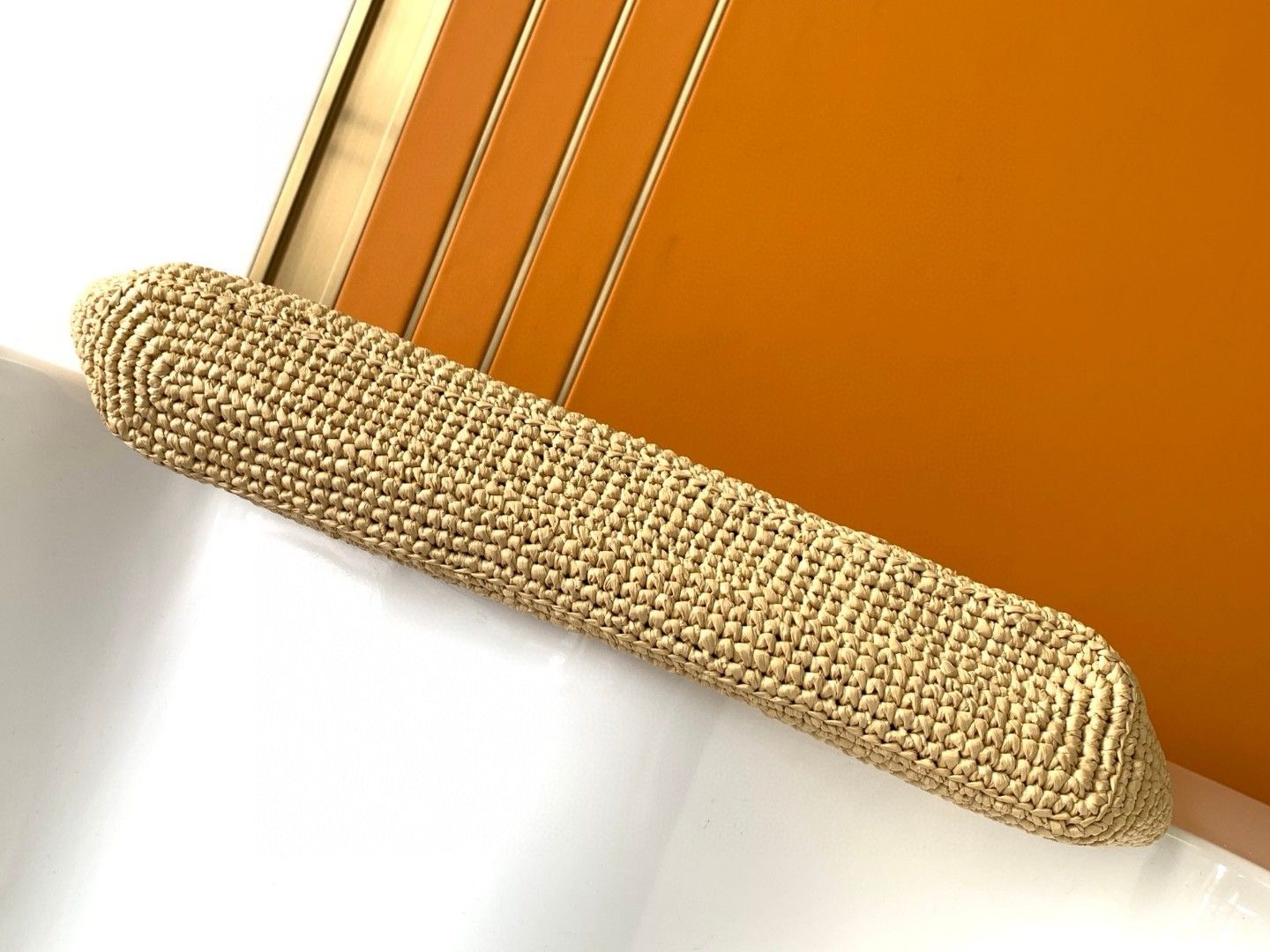 SAINT LAURENT ICare In Raffia: Handcrafted Elegance with Versatile Style. Introducing the Maxi Shopping Bag, exquisitely crafted from hand-embroidered natural raffia. This exceptional piece showcases the finest savoir-faire and specialized craftsmanship. Adorned with an oversized, sculptural Cassandre, the bag features an inner chain that can be used to adjust the sides for versatile styling. Additionally, it comes with a removable raffia sunglasses case, elegantly attached by a long chain, blending functionality with high fashion.