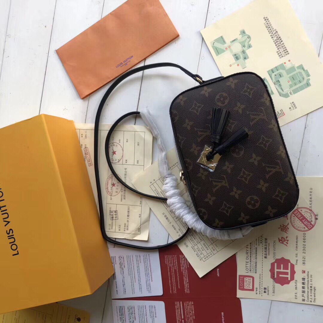 LOUIS VUITTON Saintonge Monogram Canvas Crossbody Bag. Original Quality Bag. Authentic calf leather trim and monogram coated canvas. Gold-toned Hardware. LOUIS VUITTON Sales Box and Dust Bag. Booklet, Authenticity Card, Payment Slip. Monogram canvas and smooth calfskin combine in the Saintonge, a compact bag with a youthful vibe. The leather lends contrast and volume to the design, and the tassels are a playful touch. With its top handle and long strap, the bag can be worn with top handle or as crossbody and shoulder bag.