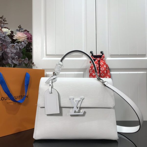 LOUIS VUITTON Grenelle MM. Authentic Quality Bag with literature, dust bag, box and authenticity card. The Grenelle MM bag combines elegance with on-trend allure. Crafted from emblematic Epi leather with smooth cowhide leather trim, this elevated day bag features a magnetic closure ornamented with an oversized, tone-on-tone LV signature. Sleek yet roomy, the MM model can be carried by the handle for a ladylike allure or worn over the shoulder on its removable strap for a more effortless attitude.