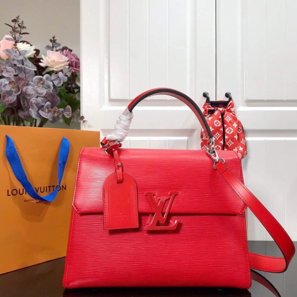 LOUIS VUITTON Grenelle MM. Authentic Quality Bag with literature, dust bag, box and authenticity card. The Grenelle MM bag combines elegance with on-trend allure. Crafted from emblematic Epi leather with smooth cowhide leather trim, this elevated day bag features a magnetic closure ornamented with an oversized, tone-on-tone LV signature. Sleek yet roomy, the MM model can be carried by the handle for a ladylike allure or worn over the shoulder on its removable strap for a more effortless attitude.
