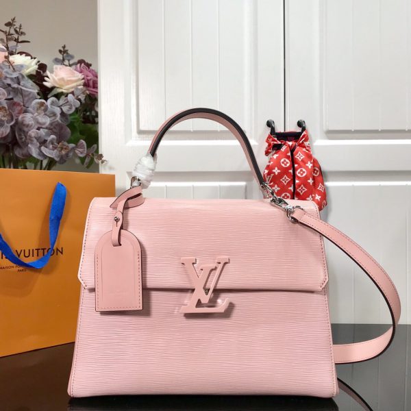 LOUIS VUITTON Grenelle MM. Authentic Quality Bag with literature, dust bag, box and authenticity card. The Grenelle MM bag combines elegance with on-trend allure. Crafted from emblematic Epi leather with smooth cowhide leather trim, this elevated day bag features a magnetic closure ornamented with an oversized, tone-on-tone LV signature. Sleek yet roomy, the MM model can be carried by the handle for a ladylike allure or worn over the shoulder on its removable strap for a more effortless attitude.