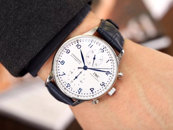 IWC 'Portugieser' Chronograph. Original Quality Watch. Authentic Sales box, authenticity card, sales slip, booklet. Stainless steel case. Fixed stainless steel bezel. Dial with steel hands and Arabic numeral hour markers. Minute markers around the outer rim. Dial Type: Analog. Luminescent hands and markers. Chronograph - two sub-dials displaying: 60 seconds and 30 minutes. Automatic movement with a 44-hour power reserve. Scratch resistant sapphire crystal. Solid case back. Case diameter: 40.9 mm. Case thickness: 12.3 mm. Round case shape. Deployment clasp. Functions: hours, minutes, seconds, chronograph. Luxury watch style.