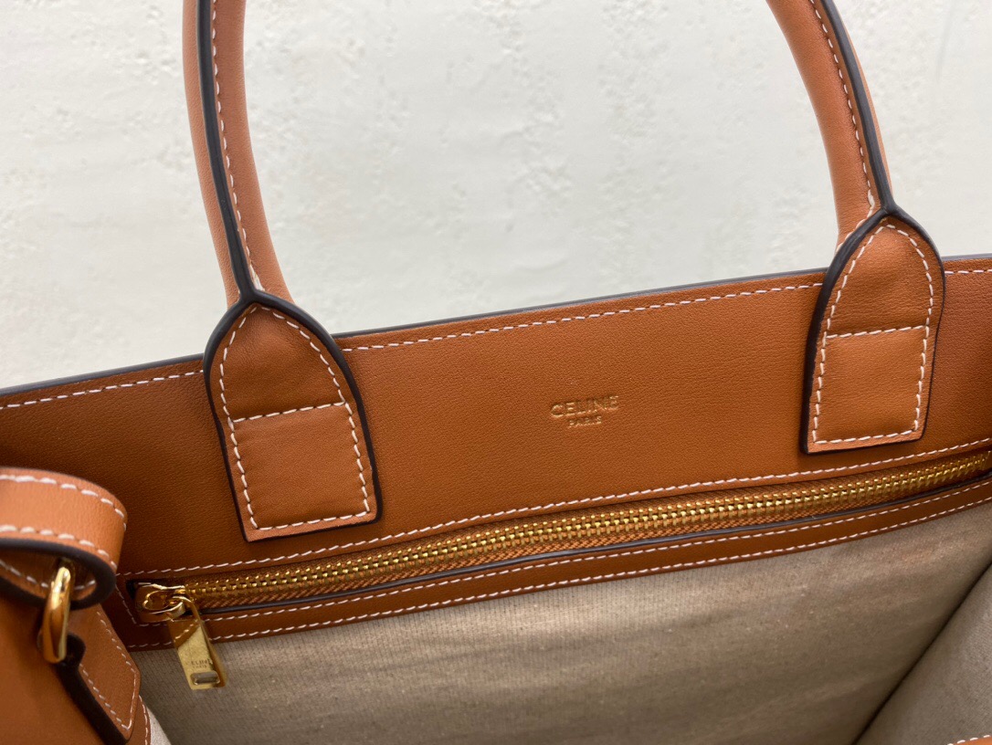 CELINE Cabas Triomphe Mini. Original Quality Bag including gift box, care book, dust bag, authenticity card. The Triomphe bag wasn’t really loved in the beginning, but its gaining traction and fame. The story started with the CELINE Triomphe bag, a magnificent bag that’s named after the Arc the Triomphe. A new chapter has started, CELINE has completed an entire collection of the Triomphe line. It includes a tote bag, bucket bag, camera bag, drawstring bag, and a Boston bag. All of these styles are made from Triomphe canvas and with calfskin trimming.