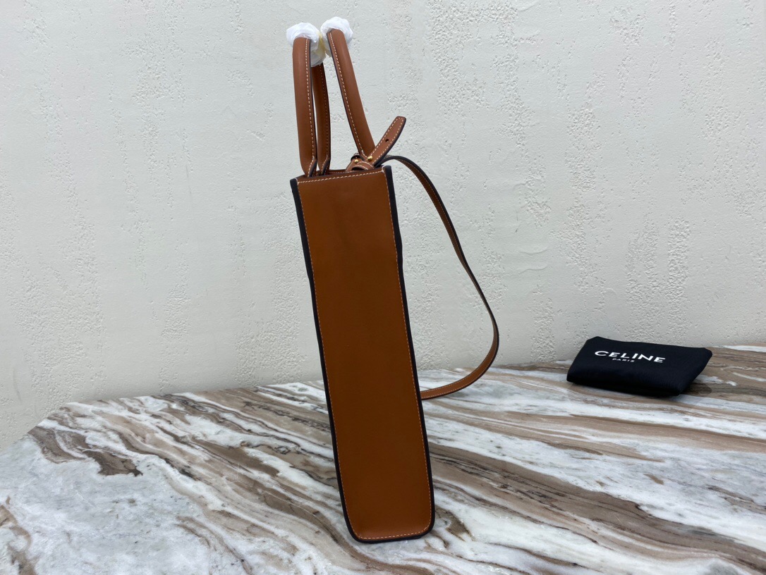 CELINE Cabas Triomphe Mini. Original Quality Bag including gift box, care book, dust bag, authenticity card. The Triomphe bag wasn’t really loved in the beginning, but its gaining traction and fame. The story started with the CELINE Triomphe bag, a magnificent bag that’s named after the Arc the Triomphe. A new chapter has started, CELINE has completed an entire collection of the Triomphe line. It includes a tote bag, bucket bag, camera bag, drawstring bag, and a Boston bag. All of these styles are made from Triomphe canvas and with calfskin trimming.