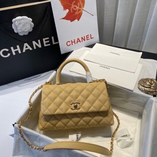 CHANEL Flap Bag with Coco Handle. Original Quality Bag including gift box, care book, dust bag, authenticity card. Despite the similarities to the Chanel Flap Bag, the Coco Handle stands apart from this and other popular Chanel models. And is perhaps the main reason behind it being unofficially renamed as the ‘Coco Handle’! The top ‘handle’ is its most distinctive feature. Structured and comfortably sized, it stands tall even when put down. The handle, combined with the trapezoid shape, bestows a modern touch to an otherwise classic style. Depending on the size you choose, the bag can find function as a day, an evening, or a day-to-night bag.