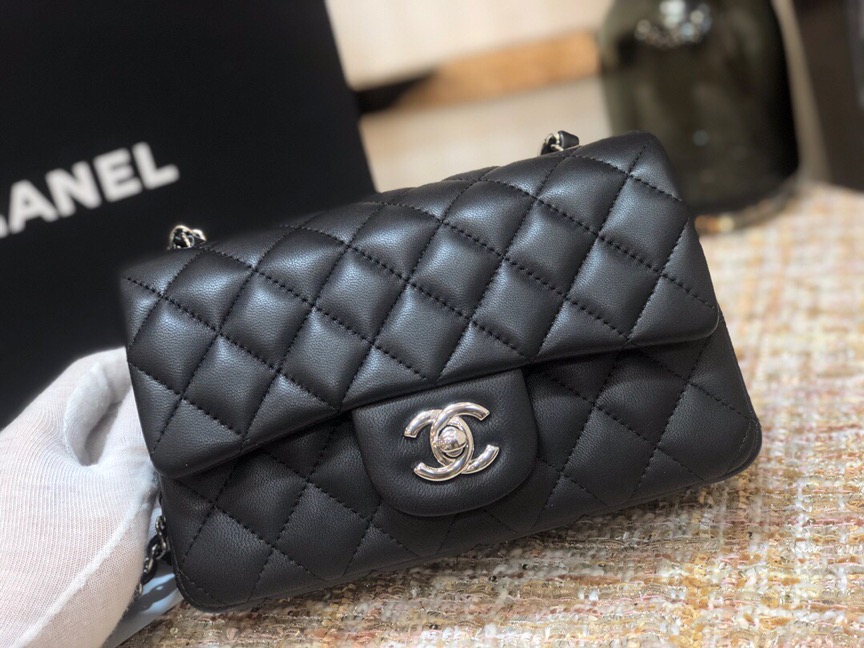 CHANEL Classic New Mini 20 cm Flap Bag. Original Quality Bag including gift box, care book, dust bag, authenticity card. This chic petite shoulder bag is crafted of luxurious shimmery lambskin leather. The crossbody bag features a long chain-link leather threaded shoulder strap and front flap with a CC turn lock. The flap opens to an interior of matching leather with zipper and patch pockets. Enjoy this fabulous bag for everyday essentials or special events with this timeless classic.