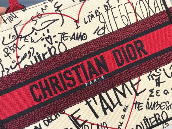 DIOR Book Tote. Original Quality Bag including gift box, care book, dust bag, authenticity card. This Book Tote is an original style introduced by Creative Director Maria Grazia Chiuri. This has become a staple of the Dior aesthetic. Ideally designed to carry all your daily essentials, the small shape is fully embroidered and the 'Christian Dior' signature on the front. This carryall is a perfect example of the Dior savoir-faire and also may be coordinated with a pouch or other small leather goods for a complete look.