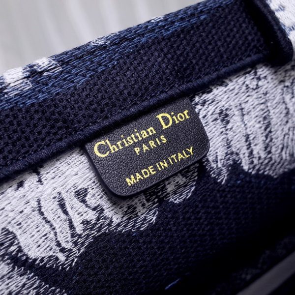 DIOR Book Tote. Original Quality Bag including gift box, care book, dust bag, authenticity card. This Book Tote is an original style introduced by Creative Director Maria Grazia Chiuri. This has become a staple of the Dior aesthetic. Ideally designed to carry all your daily essentials, the small shape is fully embroidered and the 'Christian Dior' signature on the front. This carryall is a perfect example of the Dior savoir-faire and also may be coordinated with a pouch or other small leather goods for a complete look.