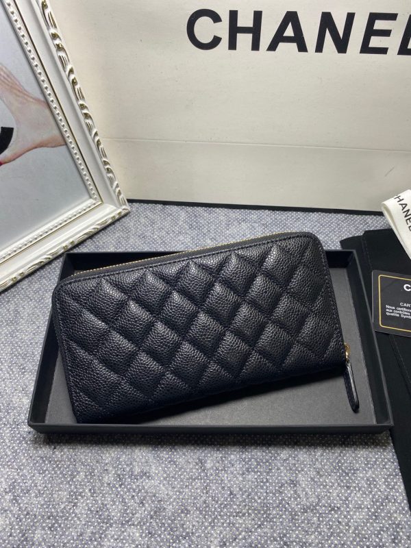 CHANEL Classic Long Zipped Wallet.  Original Quality Wallet including gift box, care book, dust bag, authenticity card. This wallet is one of the signature wallets of Chanel. It has been around for some time now and it will continue to stick around. This wallet is practical and amazing; perfect to hold paper money, credit cards and coins. The classic black color, you will get the signature burgundy colored interior. 