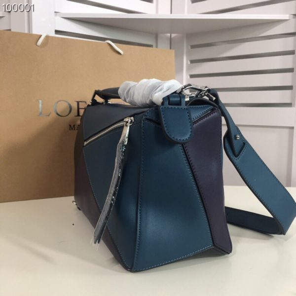 LOEWE 'Puzzle' Shoulder Bag. Original Quality Bag including gift box, care book, dust bag, authenticity card. The first completely new bag designed by Jonathan Anderson has become a LOEWE icon. With its innovative cuboid shape, extreme tactility and maximum utility, the volume is created through a precise cutting so the Puzzle bag can be worn in five different ways, from shoulder bag to clutch and folds completely until it´s flat. Key features: expertly crafted from calfskin, black hand-painted edges, herringbone-patterned cotton-canvas lining, and two internal slip compartments, handy exterior zip back pocket, embossed anagram. Removable adjustable shoulder strap for the most comfortable length.