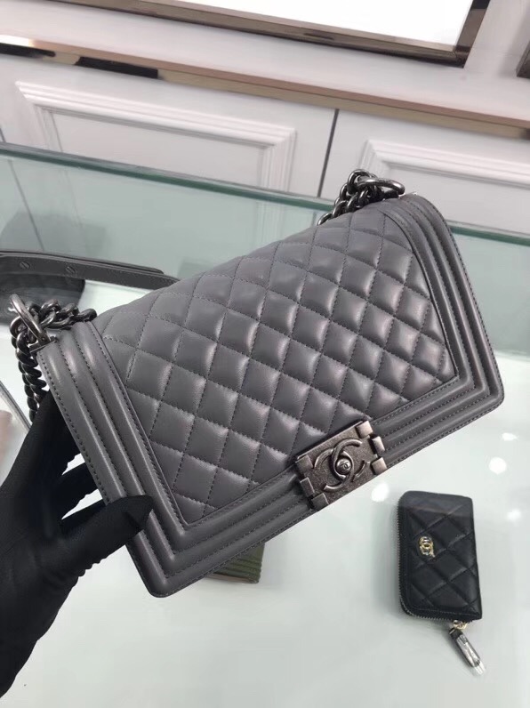 CHANEL 'Boy' Diamond Quilted Leather Flap Bag. Original Quality Bag including gift box, care book, dust bag, authenticity card. Created by Karl Lagerfeld, the iconic design owes its name to Gabrielle Chanel's first love, Boy Capel. This Chanel Boy Flap Bag Quilted is every woman's dream. Crafted from calfskin leather, the bag features Chanel's signature diamond quilting, chunky chain link strap with leather shoulder pad, and metal-tone hardware accents. Its CC Boy logo closure opens to a fabric-lined interior with slip pocket perfect for daily essentials. A sought-after, luxurious accessory.