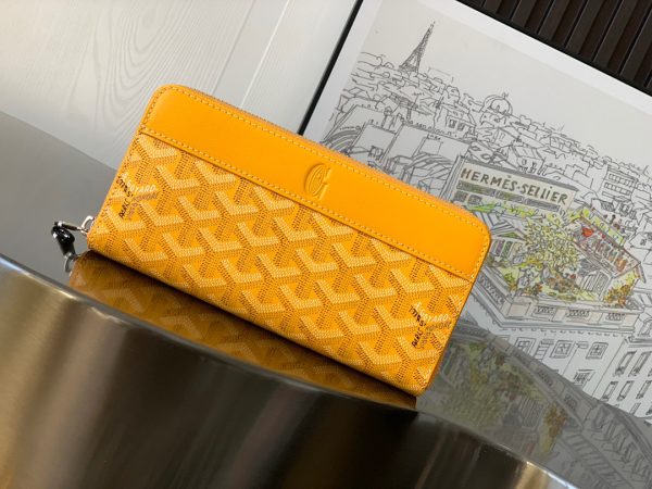 GOYARD Matignon GM Wallet: A Statement of Elegance and Functionality. Experience luxury and functionality with the Goyard Matignon GM Wallet. Crafted from premium calf leather and Goyardine canvas, it offers twelve card slots, a zipper pocket, and two spacious compartments, all secured by a snap button closure. Handcrafted by skilled artisans, Whether you're running errands or gracing a formal occasion, this wallet is the ultimate style companion. Choose from an array of colors to reflect your personality and elevate your ensemble. With this wallet, you'll not only radiate elegance but also experience unparalleled functionality.