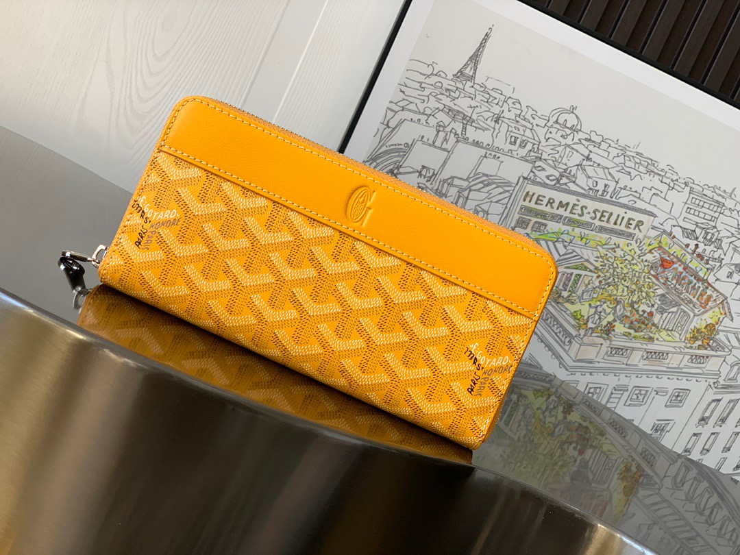 GOYARD Matignon GM Wallet: A Statement of Elegance and Functionality. Experience luxury and functionality with the Goyard Matignon GM Wallet. Crafted from premium calf leather and Goyardine canvas, it offers twelve card slots, a zipper pocket, and two spacious compartments, all secured by a snap button closure. Handcrafted by skilled artisans, Whether you're running errands or gracing a formal occasion, this wallet is the ultimate style companion. Choose from an array of colors to reflect your personality and elevate your ensemble. With this wallet, you'll not only radiate elegance but also experience unparalleled functionality.