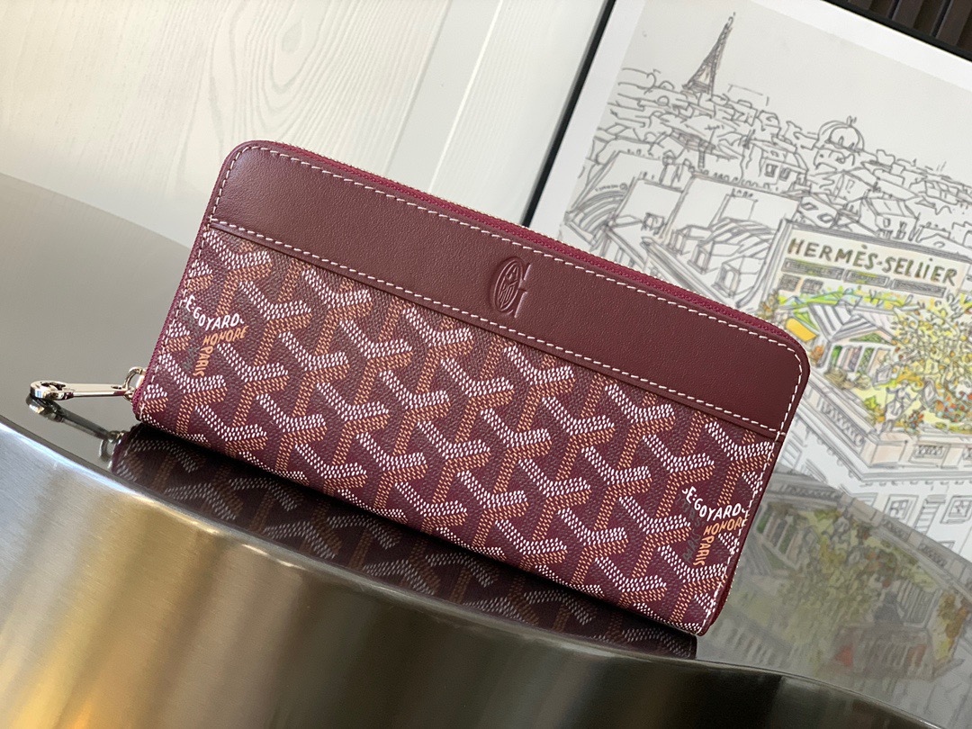 GOYARD Matignon GM Wallet: A Statement of Elegance and Functionality. Experience luxury and functionality with the Goyard Matignon GM Wallet. Crafted from premium calf leather and Goyardine canvas, it offers twelve card slots, a zipper pocket, and two spacious compartments, all secured by a snap button closure. Handcrafted by skilled artisans, Whether you're running errands or gracing a formal occasion, this wallet is the ultimate style companion. Choose from an array of colors to reflect your personality and elevate your ensemble. With this wallet, you'll not only radiate elegance but also experience unparalleled functionality.