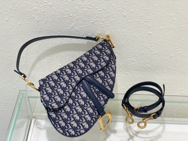 DIOR Saddle Bag With Strap. Original Quality Bag including gift box, care book, dust bag, authenticity card. Maria Grazia Chiuri brings a fresh update to the iconic Saddle bag. Crafted in grained calfskin, the legendary design features a Saddle flap with a magnetic 'D' stirrup clasp, as well as an antique gold-finish metal 'CD' signature on either side of the strap. Featuring a thin, adjustable and removable shoulder strap, the Saddle bag may be carried by hand, worn over the shoulder or crossbody.