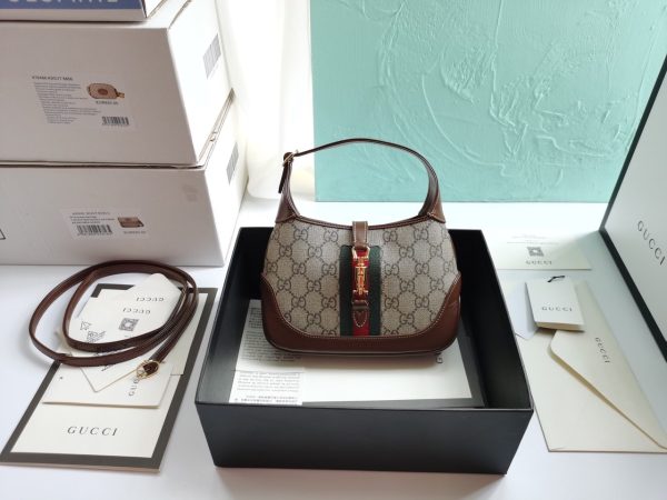 GUCCI Jackie 1961 Mini Hobo Bag. Original Quality Bag including gift box, care book, dust bag, authenticity card. The reintroduction of the Jackie bag in a mini size presents a new take on a historical Gucci icon. Brought back to the forefront, the recognizable shape is presented in leather and enhanced with an additional, detachable shoulder strap. Attached to the bag with a buckle closure, the second strap adds a contemporary feel to the archival style, providing new ways to wear—from top handle, shoulder to cross body. Pieces with versatile ways to wear and style embrace each person who is part of the House’s individual spirit.