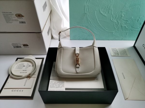 GUCCI Jackie 1961 Mini Hobo Bag. Original Quality Bag including gift box, care book, dust bag, authenticity card. The reintroduction of the Jackie bag in a mini size presents a new take on a historical Gucci icon. Brought back to the forefront, the recognizable shape is presented in leather and enhanced with an additional, detachable shoulder strap. Attached to the bag with a buckle closure, the second strap adds a contemporary feel to the archival style, providing new ways to wear—from top handle, shoulder to cross body. Pieces with versatile ways to wear and style embrace each person who is part of the House’s individual spirit.