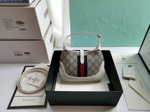 GUCCI Jackie 1961 Mini Hobo Bag. Original Quality Bag including gift box, care book, dust bag, authenticity card. The reintroduction of the Jackie bag in a mini size presents a new take on a historical Gucci icon. Brought back to the forefront, the recognizable shape is presented in leather and enhanced with an additional, detachable shoulder strap. Attached to the bag with a buckle closure, the second strap adds a contemporary feel to the archival style, providing new ways to wear—from top handle, shoulder to cross body. Pieces with versatile ways to wear and style embrace each person who is part of the House’s individual spirit.