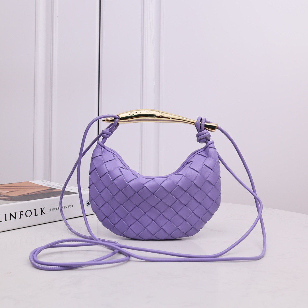 BOTTEGA VENETA Mini Sardine. Crafted to Perfection, Inspired by Nature: Your Timeless Companion for All Occasions. Bottega Veneta's masterful intrecciato weaving technique was originally crafted to ensure the enduring quality of leather goods. The Sardine Mini leather shoulder bag, meticulously fashioned from supple lamb leather, showcases a distinctive top handle reminiscent of a graceful fish. This versatile piece seamlessly transitions from day to night, making it the perfect, reliable companion to elegantly accommodate all your essentials.