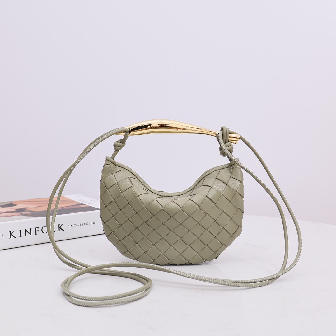 BOTTEGA VENETA Mini Sardine. Crafted to Perfection, Inspired by Nature: Your Timeless Companion for All Occasions. Bottega Veneta's masterful intrecciato weaving technique was originally crafted to ensure the enduring quality of leather goods. The Sardine Mini leather shoulder bag, meticulously fashioned from supple lamb leather, showcases a distinctive top handle reminiscent of a graceful fish. This versatile piece seamlessly transitions from day to night, making it the perfect, reliable companion to elegantly accommodate all your essentials.
