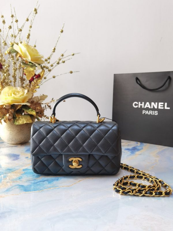 CHANEL 20 New Classic Mini Flap Bag With Handle. Original Quality Bag including gift box, care book, dust bag, authenticity card. This chic petite shoulder bag is crafted of luxurious shimmery lambskin leather. The crossbody bag features a long adjustable chain-link leather threaded shoulder strap and front flap with a CC turn lock. The flap opens to an interior of matching leather with zipper and patch pockets. Enjoy this fabulous bag for everyday essentials or special events.