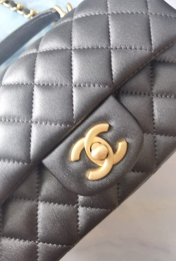 CHANEL 20 New Classic Mini Flap Bag With Handle. Original Quality Bag including gift box, care book, dust bag, authenticity card. This chic petite shoulder bag is crafted of luxurious shimmery lambskin leather. The crossbody bag features a long adjustable chain-link leather threaded shoulder strap and front flap with a CC turn lock. The flap opens to an interior of matching leather with zipper and patch pockets. Enjoy this fabulous bag for everyday essentials or special events.