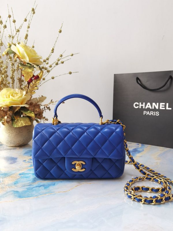 CHANEL 20 New Classic Mini Flap Bag With Handle. Original Quality Bag including gift box, care book, dust bag, authenticity card. This chic petite shoulder bag is crafted of luxurious shimmery lambskin leather. The crossbody bag features a long adjustable chain-link leather threaded shoulder strap and front flap with a CC turn lock. The flap opens to an interior of matching leather with zipper and patch pockets. Enjoy this fabulous bag for everyday essentials or special events.