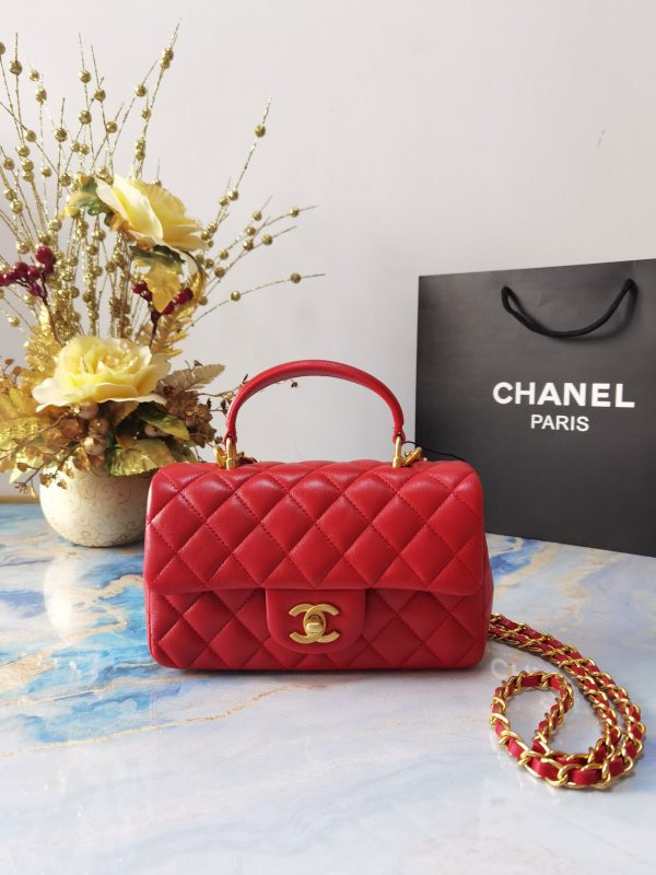CHANEL 20 New Classic Mini Flap Bag With Handle. Original Quality Bag including gift box, care book, dust bag, authenticity card. This chic petite shoulder bag is crafted of luxurious shimmery lambskin leather. The crossbody bag features a long adjustable chain-link leather threaded shoulder strap and front flap with a CC turn lock. The flap opens to an interior of matching leather with zipper and patch pockets. Enjoy this fabulous bag for everyday essentials or special events.