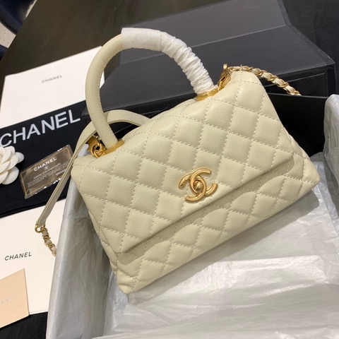 CHANEL Flap Bag with Coco Handle. Original Quality Bag including gift box, care book, dust bag, authenticity card. Despite the similarities to the Chanel Flap Bag, the Coco Handle stands apart from this and other popular Chanel models. And is perhaps the main reason behind it being unofficially renamed as the ‘Coco Handle’! The top ‘handle’ is its most distinctive feature. Structured and comfortably sized, it stands tall even when put down. The handle, combined with the trapezoid shape, bestows a modern touch to an otherwise classic style. Depending on the size you choose, the bag can find function as a day, an evening, or a day-to-night bag.