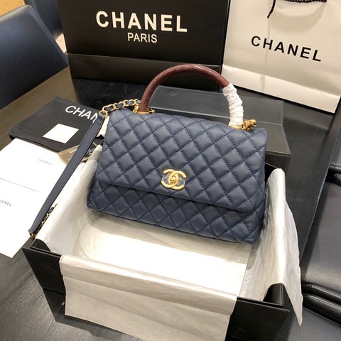 CHANEL Flap Bag with Coco Handle. Original Quality Bag including gift box, care book, dust bag, authenticity card. Despite the similarities to the Chanel Flap Bag, the Coco Handle stands apart from this and other popular Chanel models. And is perhaps the main reason behind it being unofficially renamed as the ‘Coco Handle’! The top ‘handle’ is its most distinctive feature. Structured and comfortably sized, it stands tall even when put down. The handle, combined with the trapezoid shape, bestows a modern touch to an otherwise classic style. Depending on the size you choose, the bag can find function as a day, an evening, or a day-to-night bag.