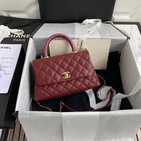 CHANEL Flap Bag with Coco Handle. Original Quality Bag including gift box, care book, dust bag, authenticity card. Despite the similarities to the Chanel Flap Bag, the Coco Handle stands apart from this and other popular Chanel models. And is perhaps the main reason behind it being unofficially renamed as the ‘Coco Handle’! The top ‘handle’ is its most distinctive feature. Structured and comfortably sized, it stands tall even when put down. The handle, combined with the trapezoid shape, bestows a modern touch to an otherwise classic style. Depending on the size you choose, the bag can find function as a day, an evening, or a day-to-night bag.