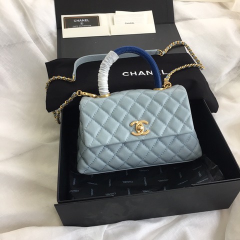 CHANEL Flap Bag with Coco Handle. Original Quality Bag including gift box, care book, dust bag, authenticity card. Despite the similarities to the Chanel Flap Bag, the Coco Handle stands apart from this and other popular Chanel models. And is perhaps the main reason behind it being unofficially renamed as the ‘Coco Handle’! The top ‘handle’ is its most distinctive feature. Structured and comfortably sized, it stands tall even when put down. The handle, combined with the trapezoid shape, bestows a modern touch to an otherwise classic style. Depending on the size you choose, the bag can find function as a day, an evening, or a day-to-night bag.