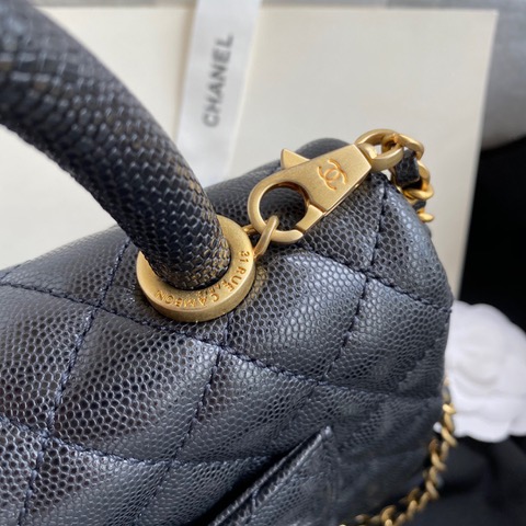 CHANEL Flap Bag with Coco Handle. Original Quality Bag including gift box, care book, dust bag, authenticity card. Despite the similarities to the Chanel Flap Bag, the Coco Handle stands apart from this and other popular Chanel models. And is perhaps the main reason behind it being unofficially renamed as the ‘Coco Handle’! The top ‘handle’ is its most distinctive feature. Structured and comfortably sized, it stands tall even when put down. The handle, combined with the trapezoid shape, bestows a modern touch to an otherwise classic style. Depending on the size you choose, the bag can find function as a day, an evening, or a day-to-night bag.