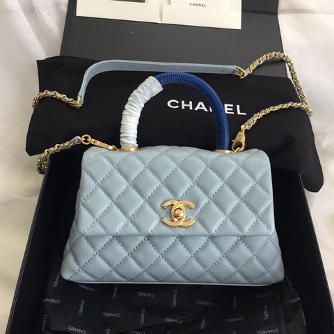 CHANEL Flap Bag with Coco Handle. Original Quality Bag including gift box, care book, dust bag, authenticity card. Despite the similarities to the Chanel Flap Bag, the Coco Handle stands apart from this and other popular Chanel models. And is perhaps the main reason behind it being unofficially renamed as the ‘Coco Handle’! The top ‘handle’ is its most distinctive feature. Structured and comfortably sized, it stands tall even when put down. The handle, combined with the trapezoid shape, bestows a modern touch to an otherwise classic style. Depending on the size you choose, the bag can find function as a day, an evening, or a day-to-night bag.