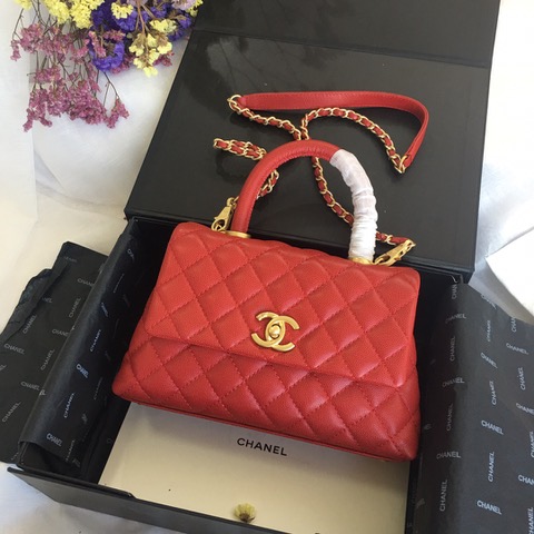 CHANEL Flap Bag with Coco Handle. Original Quality Bag including gift box, care book, dust bag, authenticity card. Despite the similarities to the Chanel Flap Bag, the Coco Handle stands apart from this and other popular Chanel models. And is perhaps the main reason behind it being unofficially renamed as the ‘Coco Handle’! The top ‘handle’ is its most distinctive feature. Structured and comfortably sized, it stands tall even when put down. The handle, combined with the trapezoid shape, bestows a modern touch to an otherwise classic style. Depending on the size you choose, the bag can find function as a day, an evening, or a day-to-night bag.