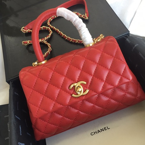 CHANEL Flap Bag with Coco Handle. Original Quality Bag including gift box, care book, dust bag, authenticity card. Despite the similarities to the Chanel Flap Bag, the Coco Handle stands apart from this and other popular Chanel models. And is perhaps the main reason behind it being unofficially renamed as the ‘Coco Handle’! The top ‘handle’ is its most distinctive feature. Structured and comfortably sized, it stands tall even when put down. The handle, combined with the trapezoid shape, bestows a modern touch to an otherwise classic style. Depending on the size you choose, the bag can find function as a day, an evening, or a day-to-night bag.